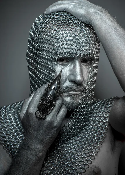 Medieval executioner in mesh iron rings on the head — Stock Photo, Image