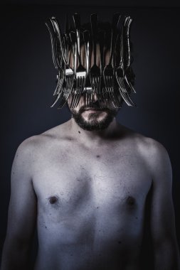 man with a crown of forks and knives