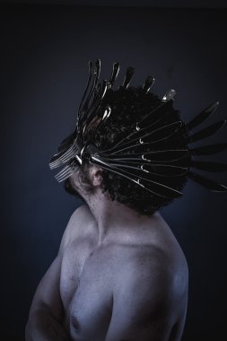 man with a crown of forks and knives