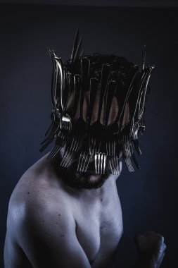man with a crown of forks and knives