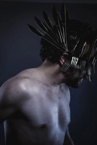 Man with a crown of forks and knives — Stock Photo, Image