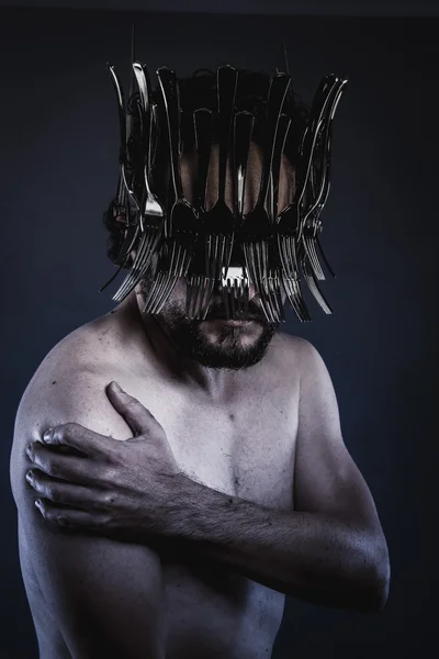 Man with a crown of forks and knives — Stock Photo, Image