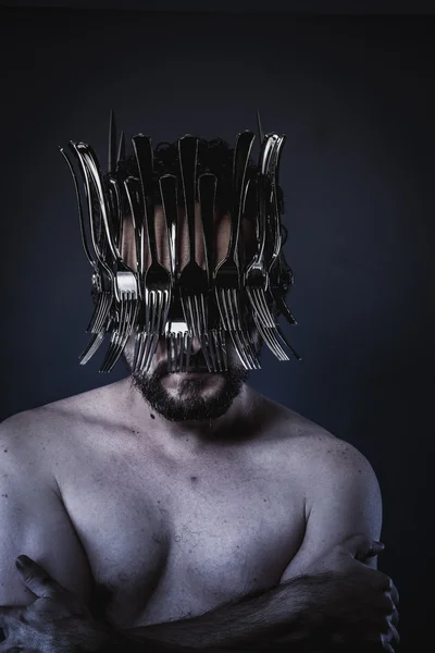 Man with a crown of forks and knives — Stock Photo, Image