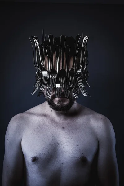 Man with a crown of forks and knives — Zdjęcie stockowe