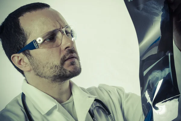 Radiologist looking at an x-ray — Stock Photo, Image