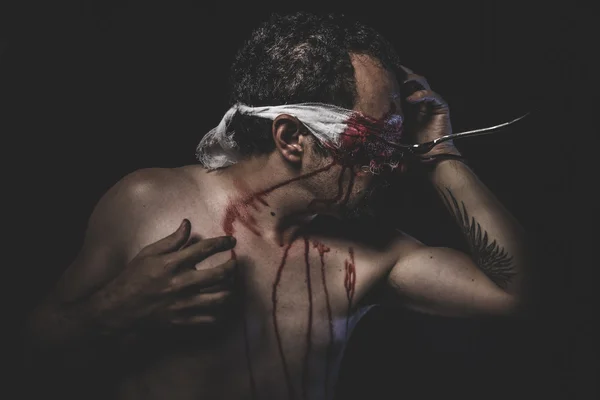 Naked man with blindfold soaked in blood — Stock Photo, Image