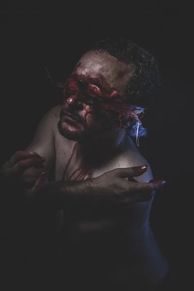 Naked man with blindfold soaked in blood — Stock Photo, Image