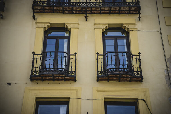 Traditional architecture with balconies and old windows, city of Segovia in Spain