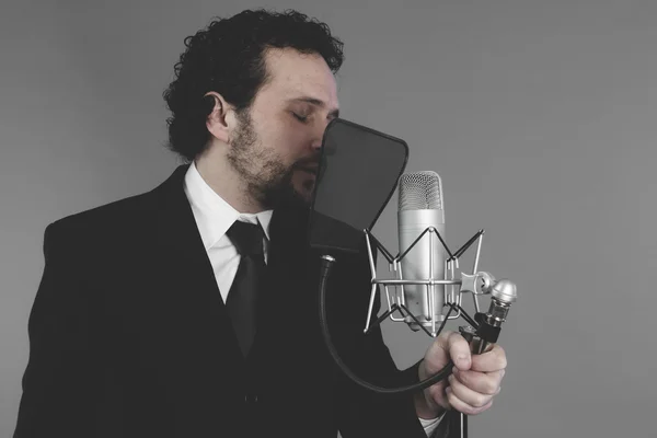 Singer in suit and microphone — Stock Photo, Image