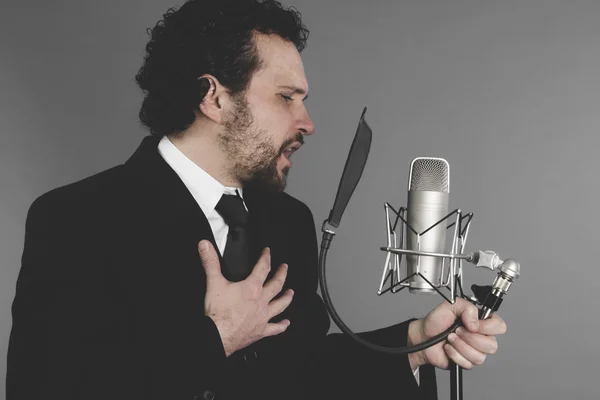 Singer in suit and microphone — Stock Photo, Image