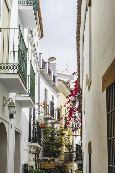 Tourism, architecture and streets of white buildings in Marbella, Andalucia, Spain