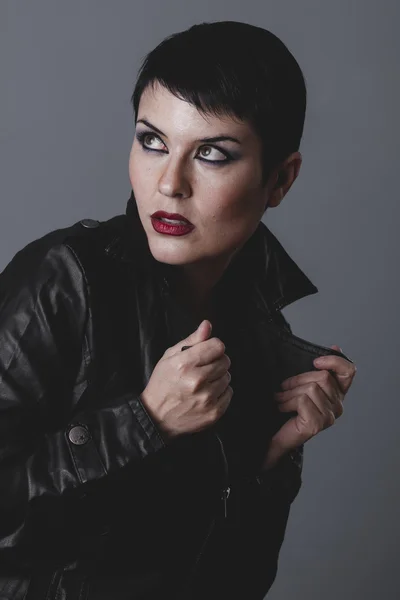 Serious girl in black leather jacket — Stock Photo, Image