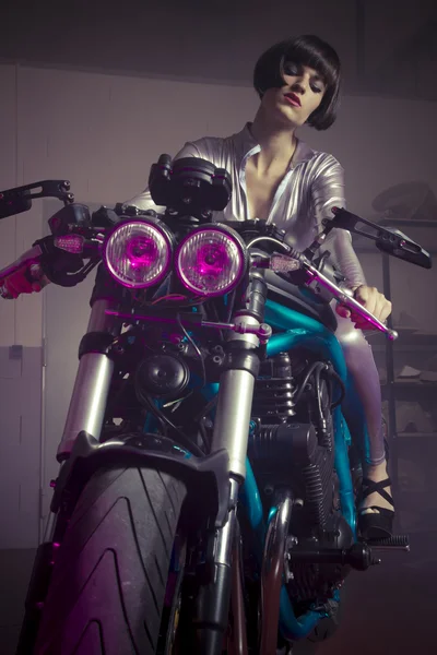 Brunette in  latex suit on a bike — Stock Photo, Image