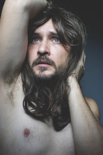 Man with long  hair posing — Stock Photo, Image