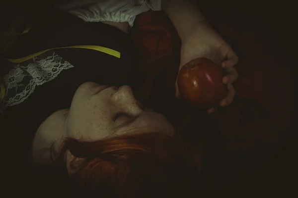 Girl  with a red apple lying — Stock Photo, Image