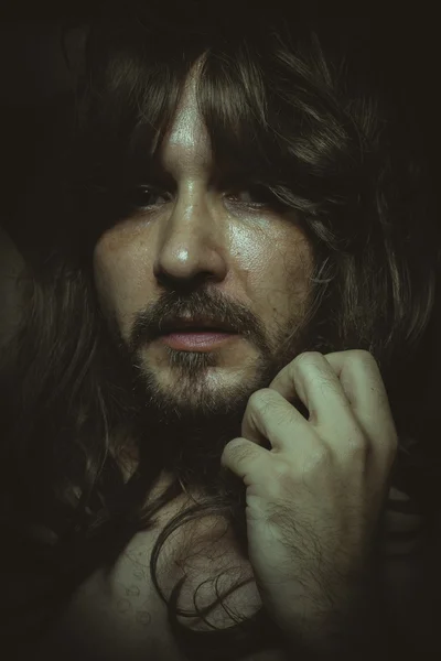 Man with long hair posing — Stock Photo, Image