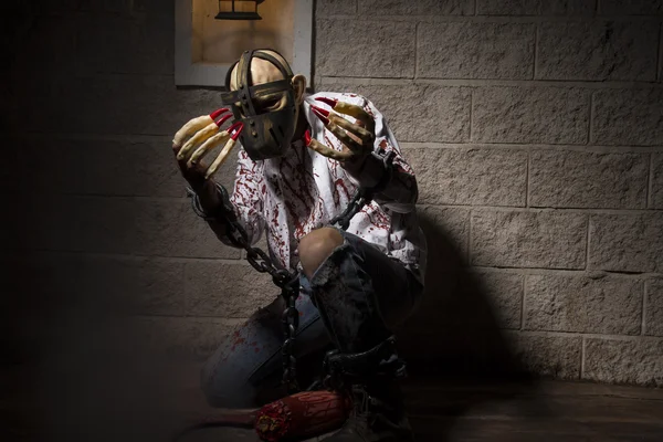 Man in mask with hands chained — Stock Photo, Image