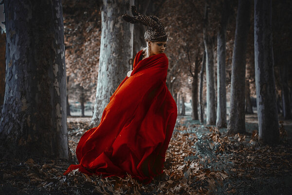 woman posing  with red cape 