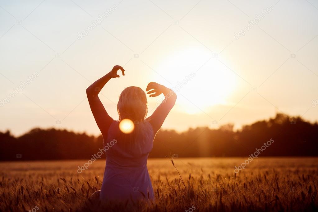 Beauty Romantic Girl Outdoors. Beautiful Teenage Model girl in Casual Short Dress on the Field in Sun Light. Blowing Long Hair. Autumn. Glow Sun, Sunshine. Backlit. Toned in warm colors