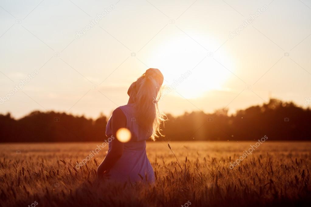 Beauty Romantic Girl Outdoors. Beautiful Teenage Model girl in Casual Short Dress on the Field in Sun Light. Blowing Long Hair. Autumn. Glow Sun, Sunshine. Backlit. Toned in warm colors