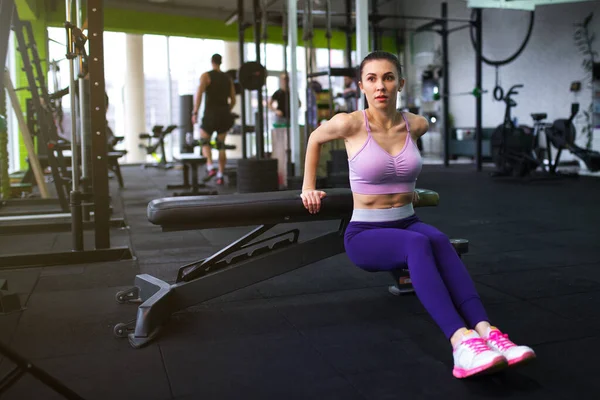 Menina bonita nova vestindo roupas de esportes de moda fazendo exercício no tapete no ginásio loft, vista superior Fotos De Bancos De Imagens