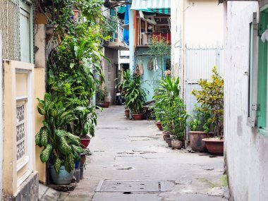Narrow backstreet in residential area of Ho Chi Minh City, Vietnam. Backstreets like this, too narrow for cars, are very common in Vietnamese cities. clipart
