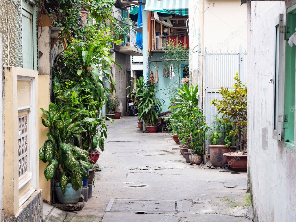 Narrow backstreet in residential area of Ho Chi Minh City, Vietnam. Backstreets like this, too narrow for cars, are very common in Vietnamese cities.