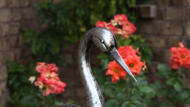 Metalen vogel standbeeld in een tuin. — Stockvideo