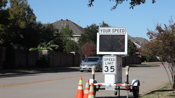 Cars speeding by a police speed sign. — Stock Video