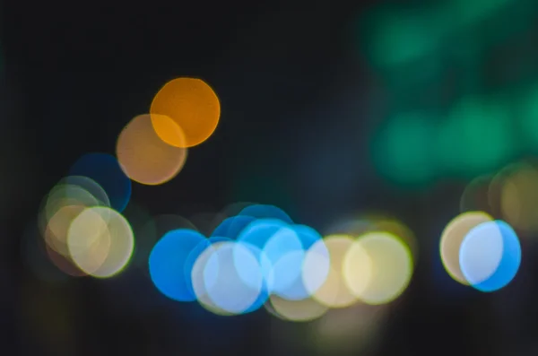 Defocused urban abstract texture, bokeh lights of city lights in the background with blurring lights — Stock Photo, Image