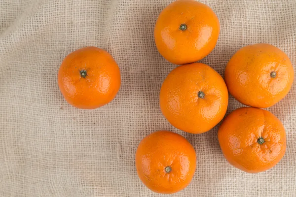 Grupo de mandarinas naranjas, mandarinas fruta en arpillera backg — Foto de Stock