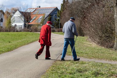 Güney Alman kırsalında bahar aylarında yürüyen yaşlı çift.