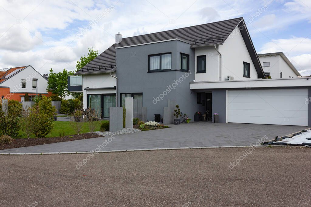 modern house facade with white and grey colors in germany spring countryside