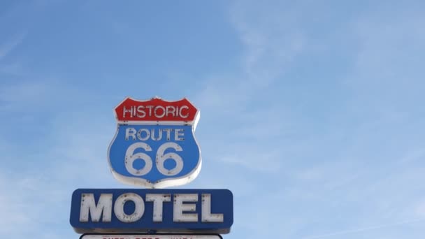 Motel retro sign on historic route 66 famous travel destination, vintage symbol of road trip in USA. Iconic lodging signboard in Arizona desert. Old-fashioned neon signage. Classic tourist landmark — Stock Video