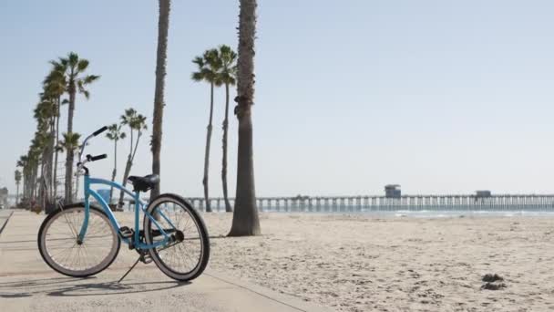 Rowerowy krążownik przy plaży ocean, wybrzeże Kalifornii USA. Cykl letni, szałas ratowniczy i palma — Wideo stockowe