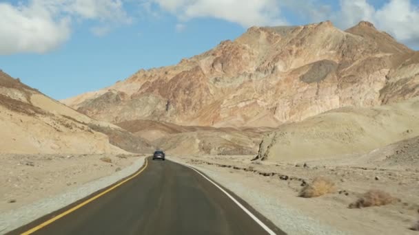 Road trip to Death Valley, Artists Palette drive, California USA. Hitchhiking auto traveling in America. Highway, colorful bare mountains and arid climate wilderness. View from car. Journey to Nevada — Stock Video