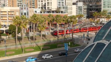 SAN DIEGO, CALIFORNIA USA - 30 HAZİRAN 2020: MTS kırmızı tramvay ve metropoldeki gökdelenler, şehir merkezindeki gökdelenler. Havadan bakıldığında Gaslamp Quarter ve tramvayındaki çeşitli binalar.