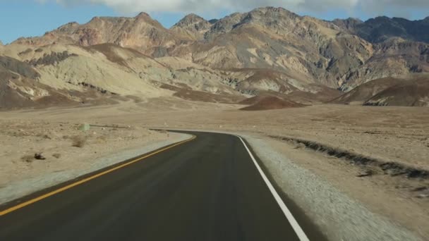 Road trip to Death Valley, Artists Palette drive, California USA. Hitchhiking auto traveling in America. Highway, colorful bare mountains and arid climate wilderness. View from car. Journey to Nevada — Stock Video