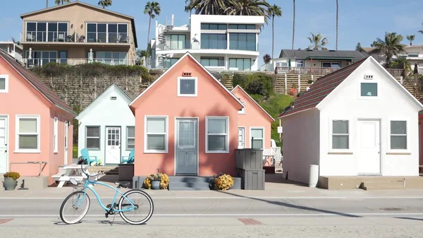 Bicycle cruiser bike by ocean beach, California coast USA. Summertime cycle, cottages and palm tree.