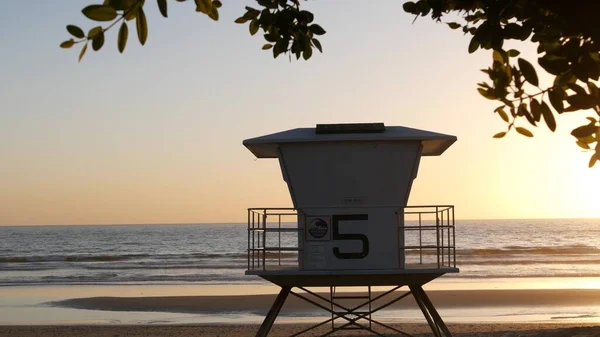 Lifeguard watch tower sunny sunset beach. Watchtower hut, pacific ocean coast. California summertime