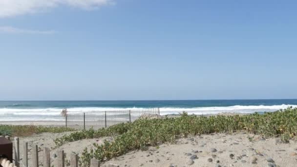 Olas de verano en la playa, costa de California, EE.UU. Costa del océano Pacífico, cerca de piquetes en la orilla del mar. — Vídeos de Stock
