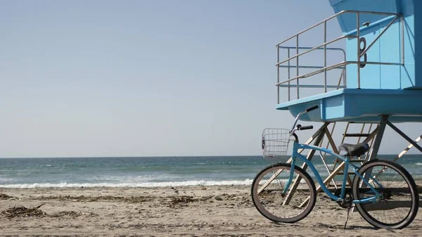 Bicycle cruiser bike by ocean beach California coast USA. Summer sea shore. Cycle by lifeguard tower — Stock Photo, Image