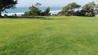 Del Mar, Kaliforniya 'daki Seagrove Parkı. Deniz kenarındaki çimenler. Yukarıdan yeşil çimenler ve okyanus manzarası.