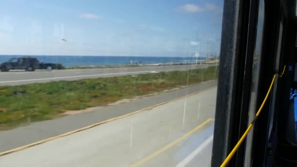 Bus window, pacific coast highway, freeway 101, California USA. Road trip along summer ocean or sea. — Stock Video