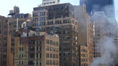 New York City şehir merkezi yerleşim binası, kırmızı kahverengi tuğla mimari, Manhattan çatısı, Amerika Birleşik Devletleri. Çatıda su kulesi, su tankları. Hells Kitchen Liman İdaresi. Sıcak buhar.