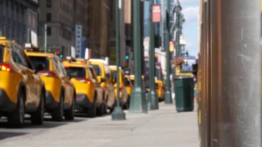 Manhattan Midtown Caddesi, New York, ABD. Sarı taksi vagonlarının çözülmüş sırası. Penn İstasyonu yakınlarındaki 8. caddede birçok taksi kuyrukta bekliyor. Taksi kuyruğu, şehir trafiği, yolcu taşımacılığı..
