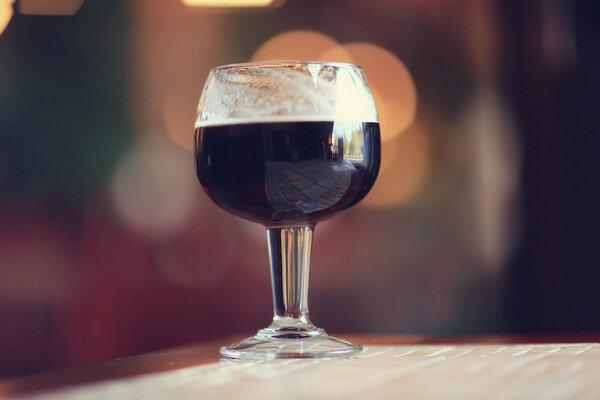 Glass of dark beer in a pub