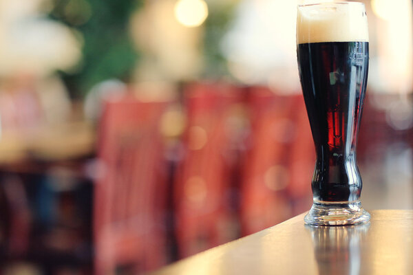 glass of dark beer on table 