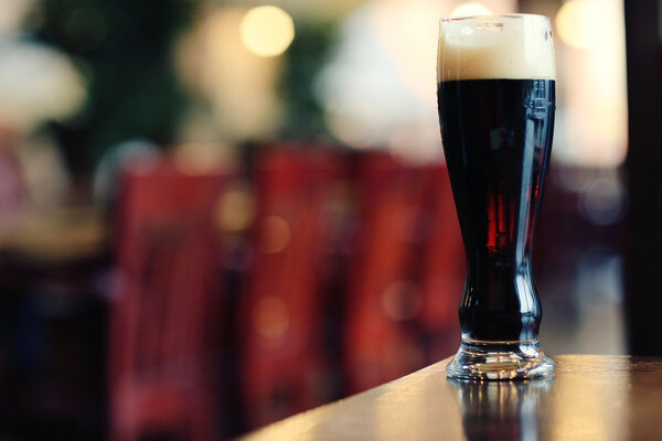 glass of dark beer on table 