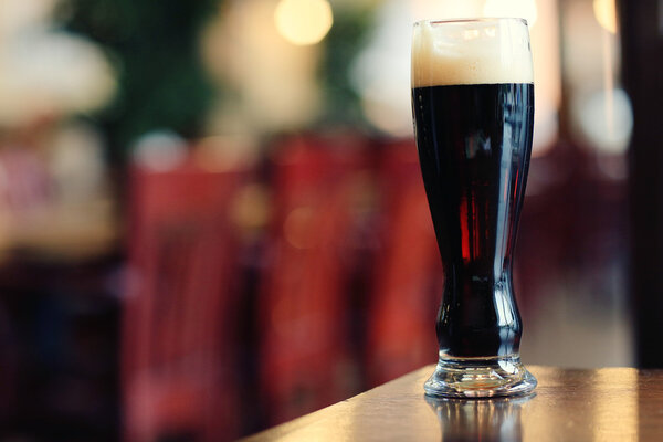 glass of dark beer on table 